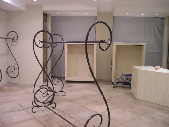 Free standing curled steel clothing hanging units and Maple Veneer boxed clothing display units